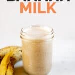 A picture of a jar with banana milk and a couple of bananas with the words banana milk