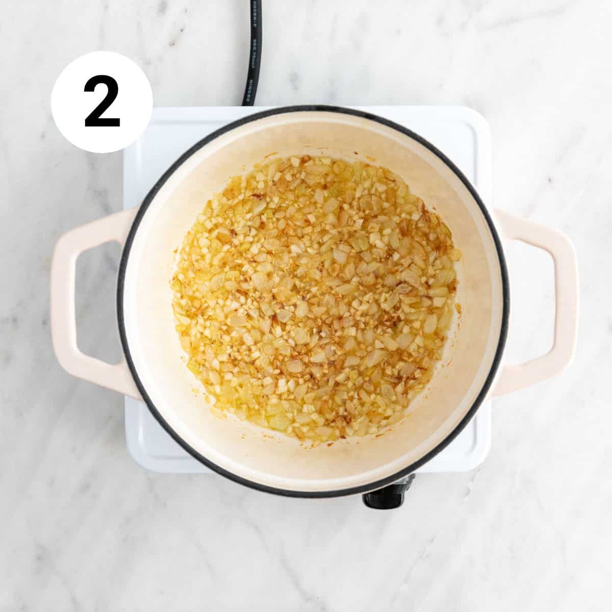 Sautéed onion and garlic in a pot.