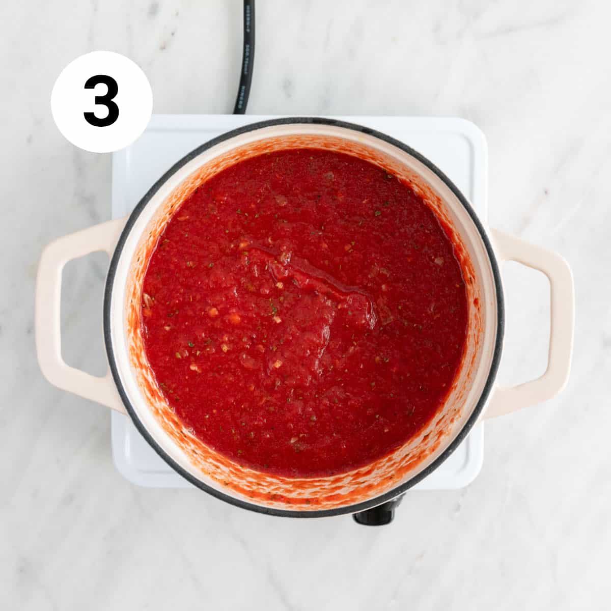Marinara sauce in a pot before blending.