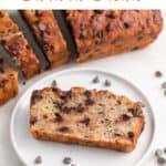 A vegan banana bread slice on a plate with a backdrop of sliced loaf.