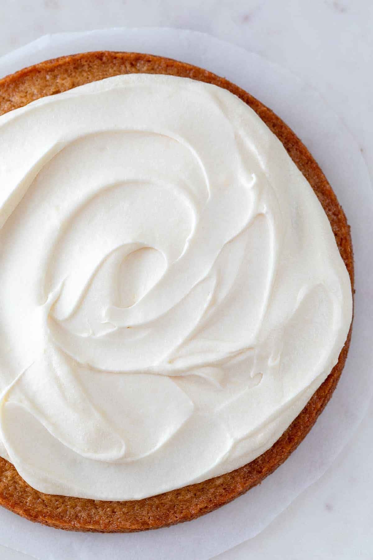 A vegan cake adorned with vegan cream cheese frosting.