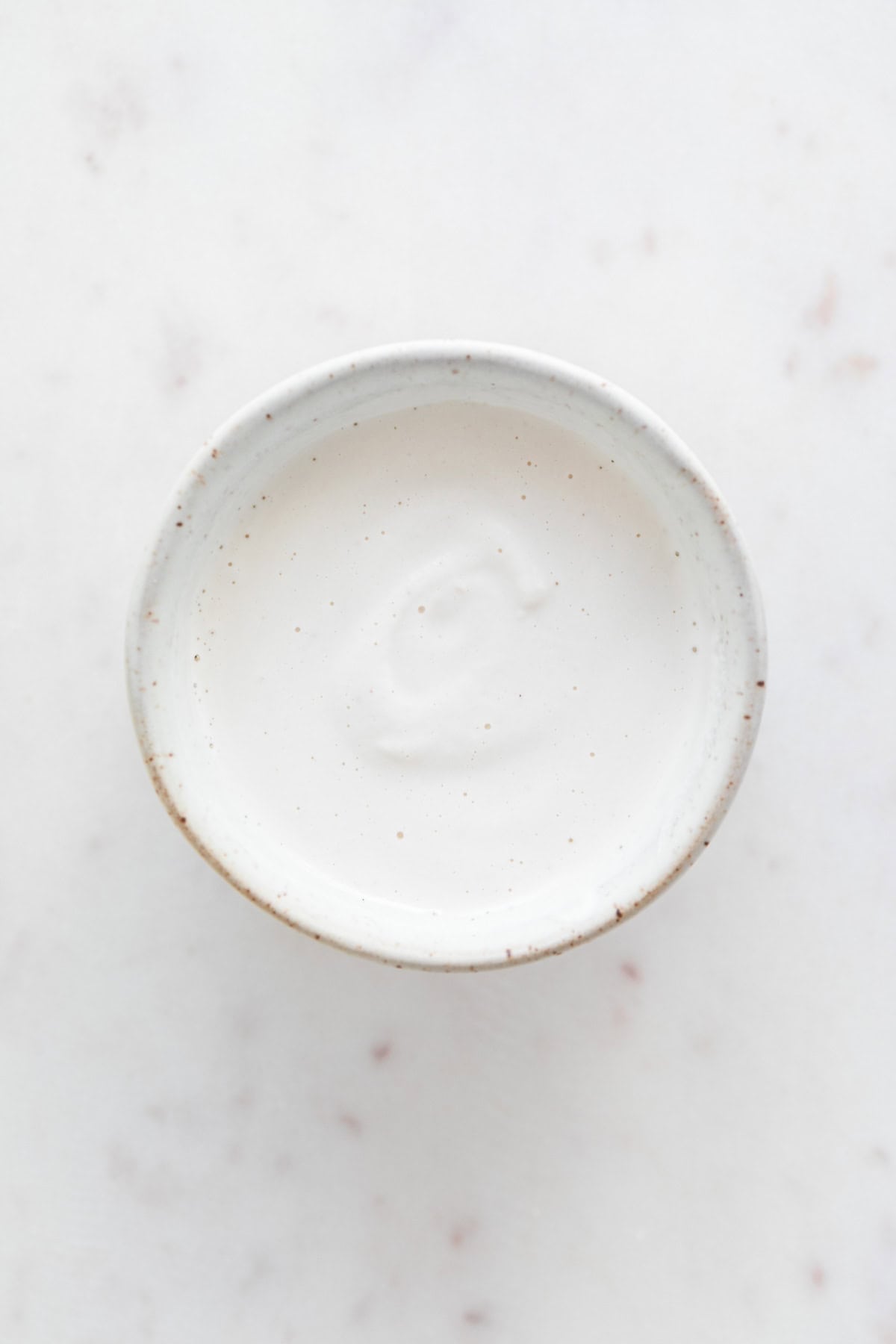 Small bowl filled with vegan heavy cream substitute.