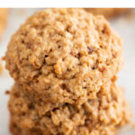 Three vegan oatmeal cookies stacked up.
