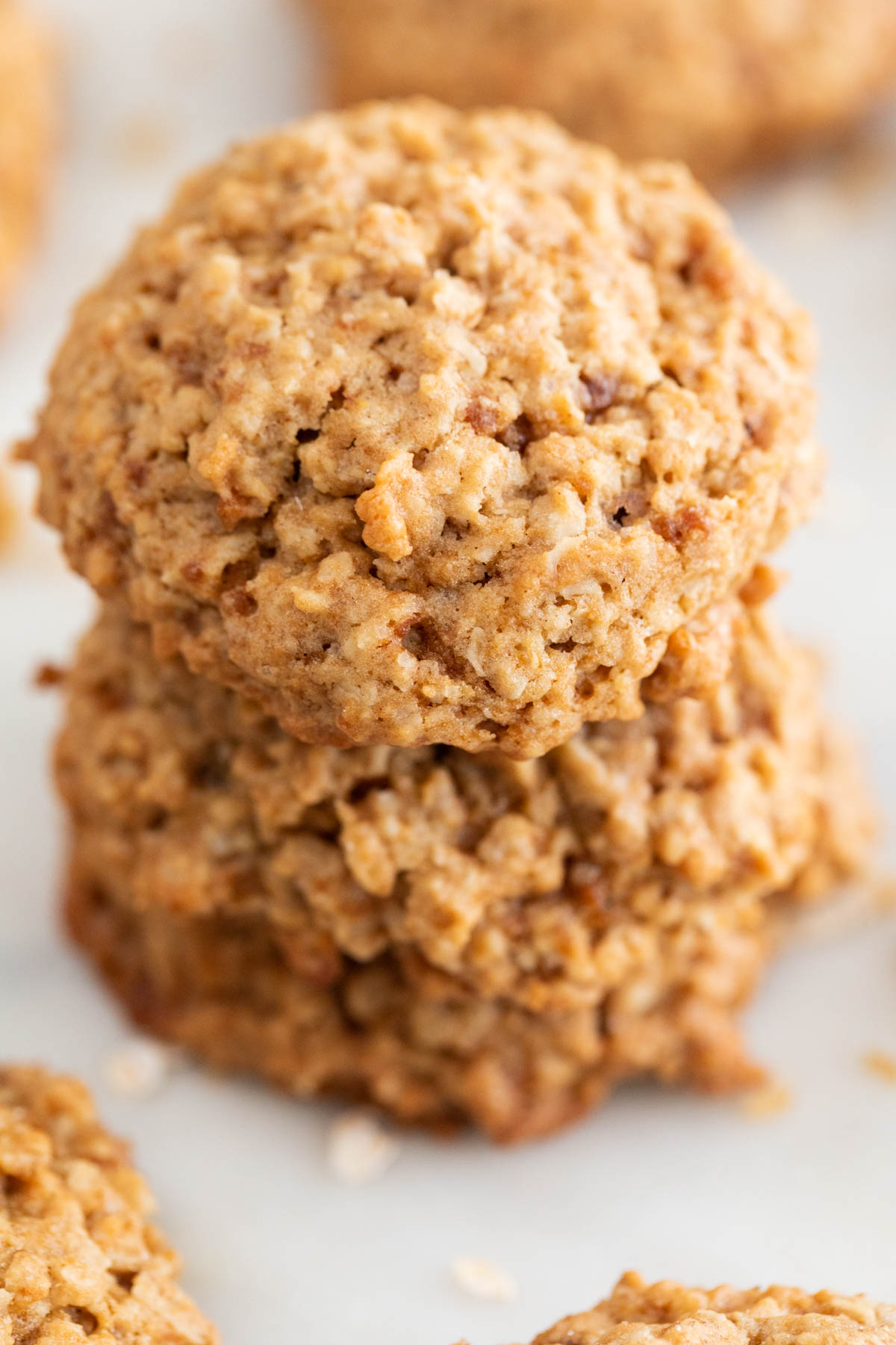 Three vegan oatmeal cookies stacked up.