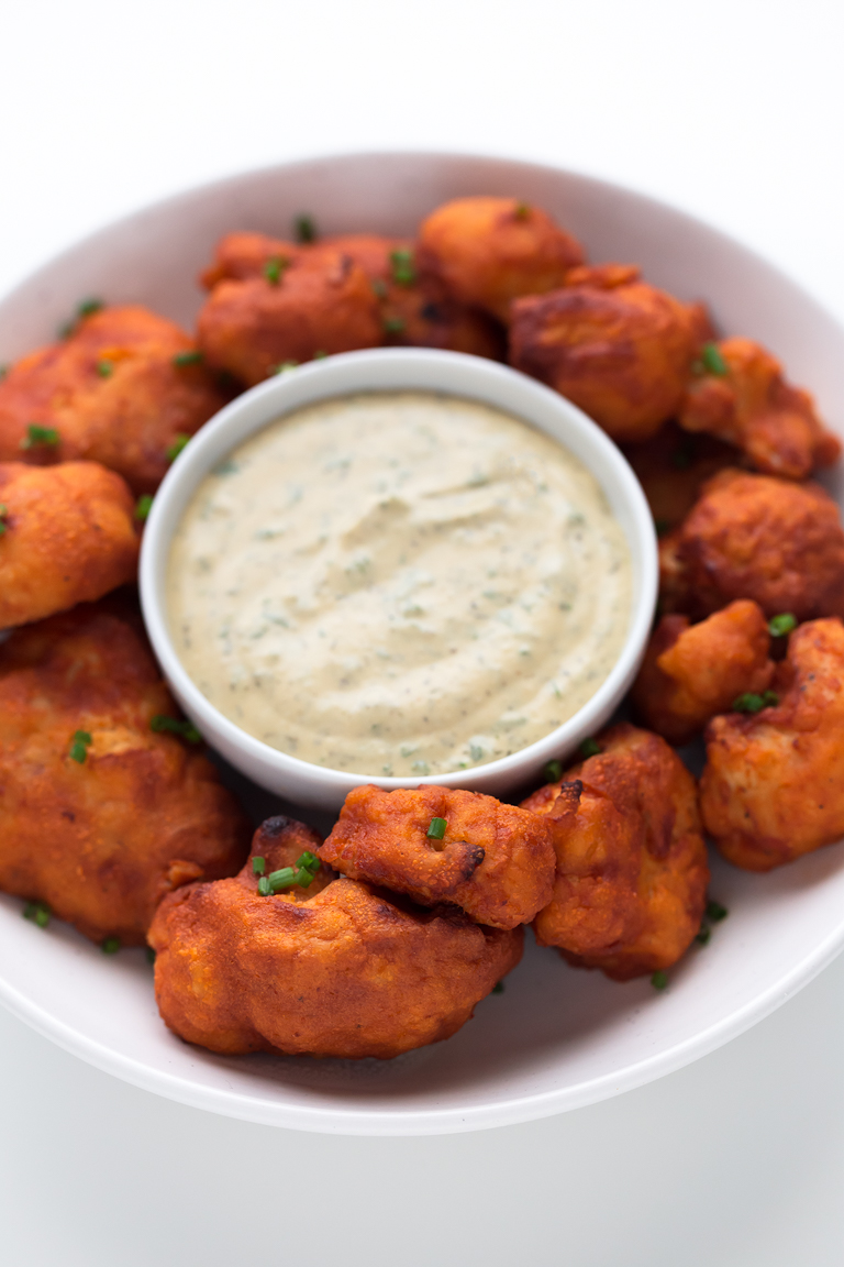 Close-up shot of a bowl of buffalo cauliflower wings