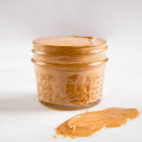 A side shot of a jar with homemade cashew butter