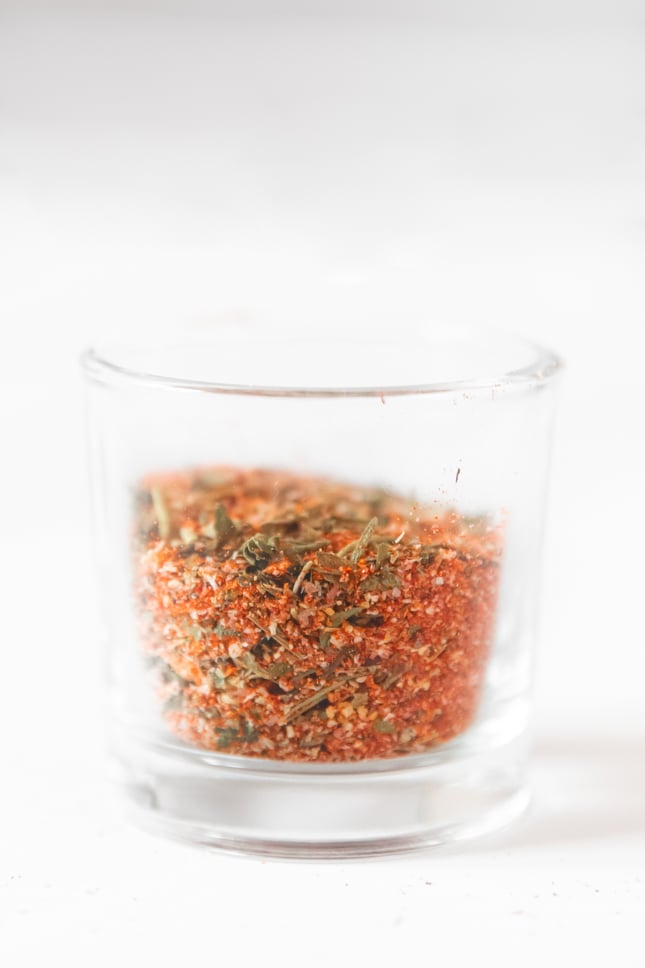 Side shot of a glass jar of chicken seasoning