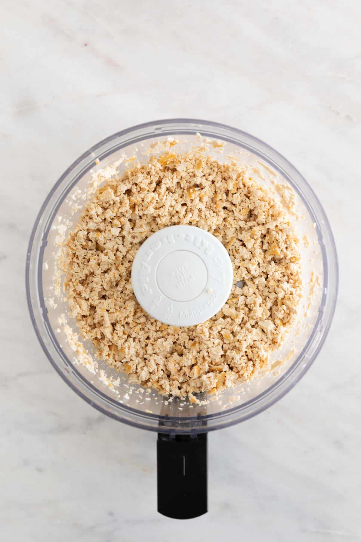 Small pieces of tofu in a food processor.