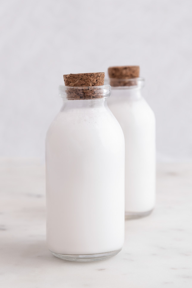 Photo of 2 glass bottles of coconut milk