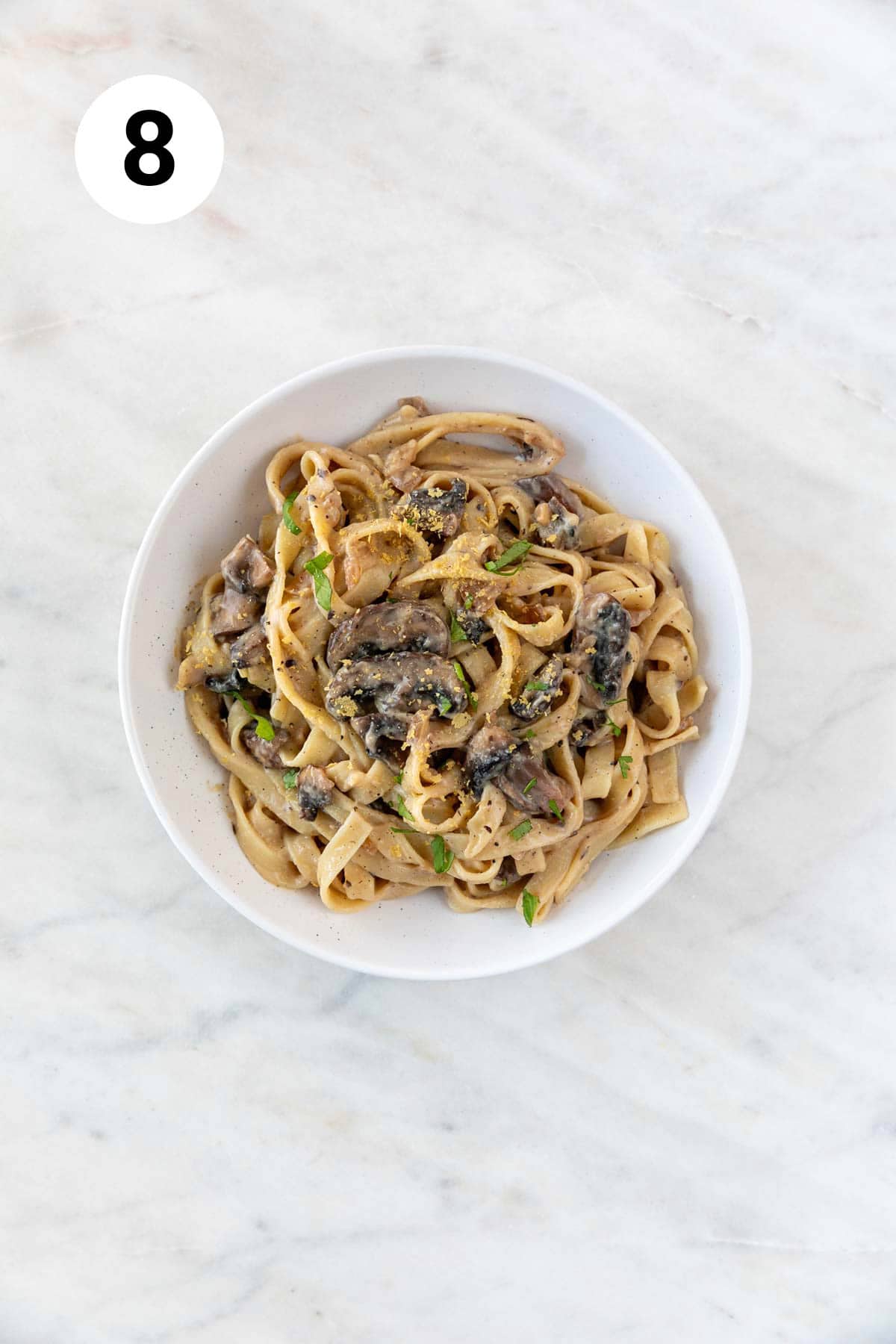 Vegan mushroom pasta in a large pot garnished with cilantro.