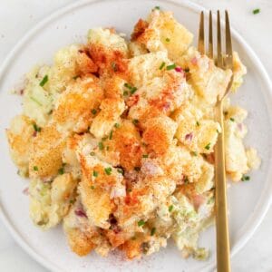 Vegan potato salad on a plate with a fork.