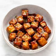 Crispy sesame tofu served in a bowl.