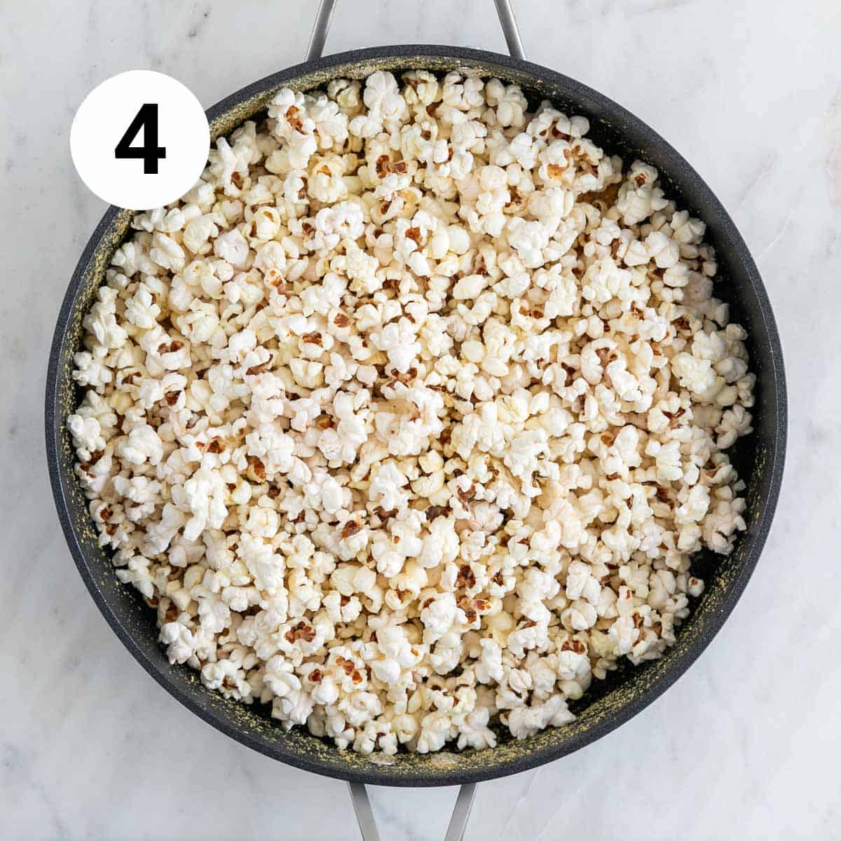 Cheesy vegan popcorn in a skillet.
