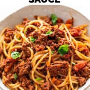 Vegan bolognese spaghetti in a bowl with basil.