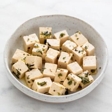 Dish holding vegan feta cheese.