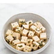 Vegan feta cheese displayed in dish.