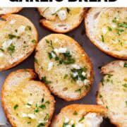 Vegan garlic bread slices onto a white surface.