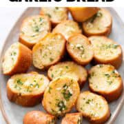 Vegan garlic bread slices on a serving dish.