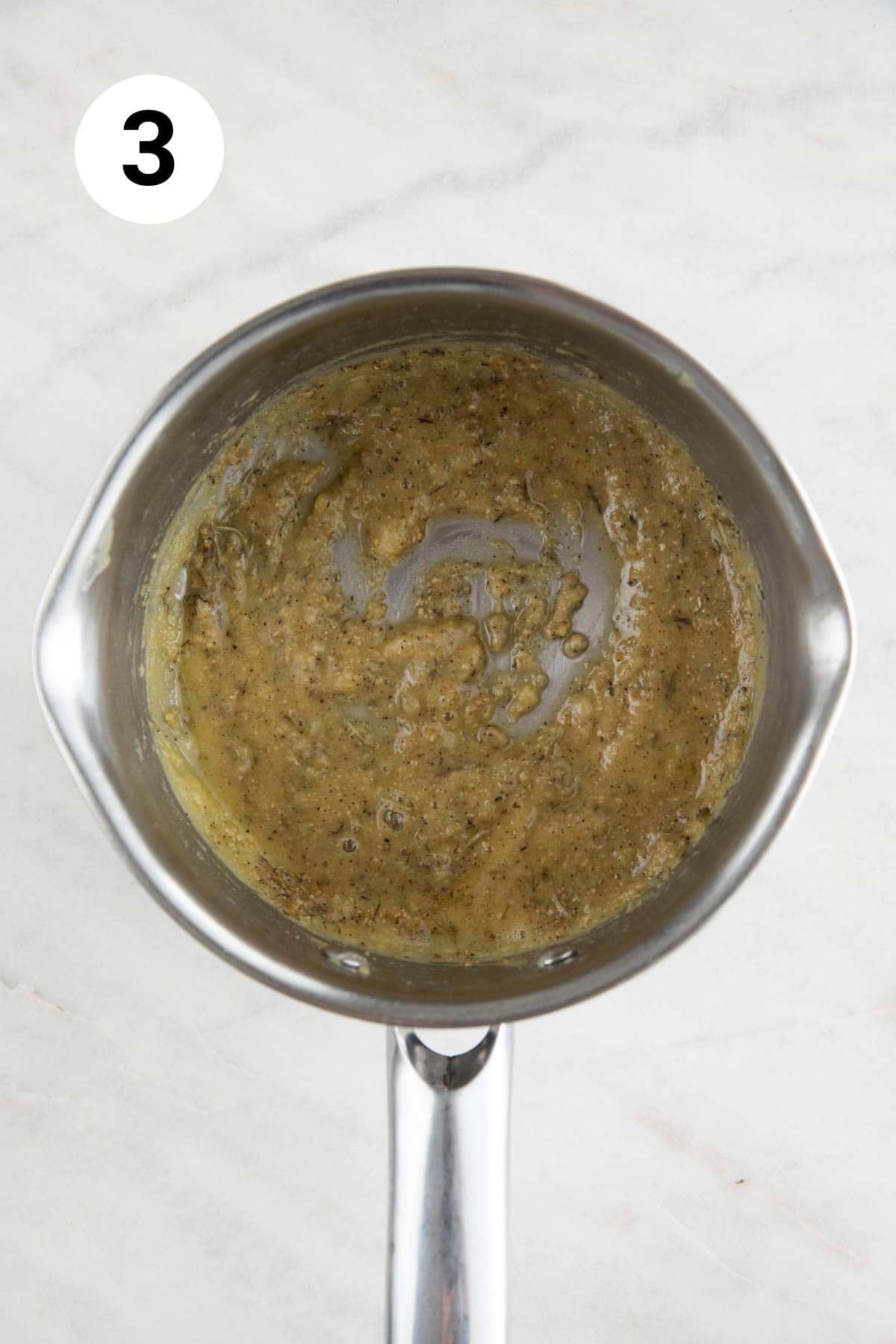 Saucepan with the cooked roux with spices and herbs.