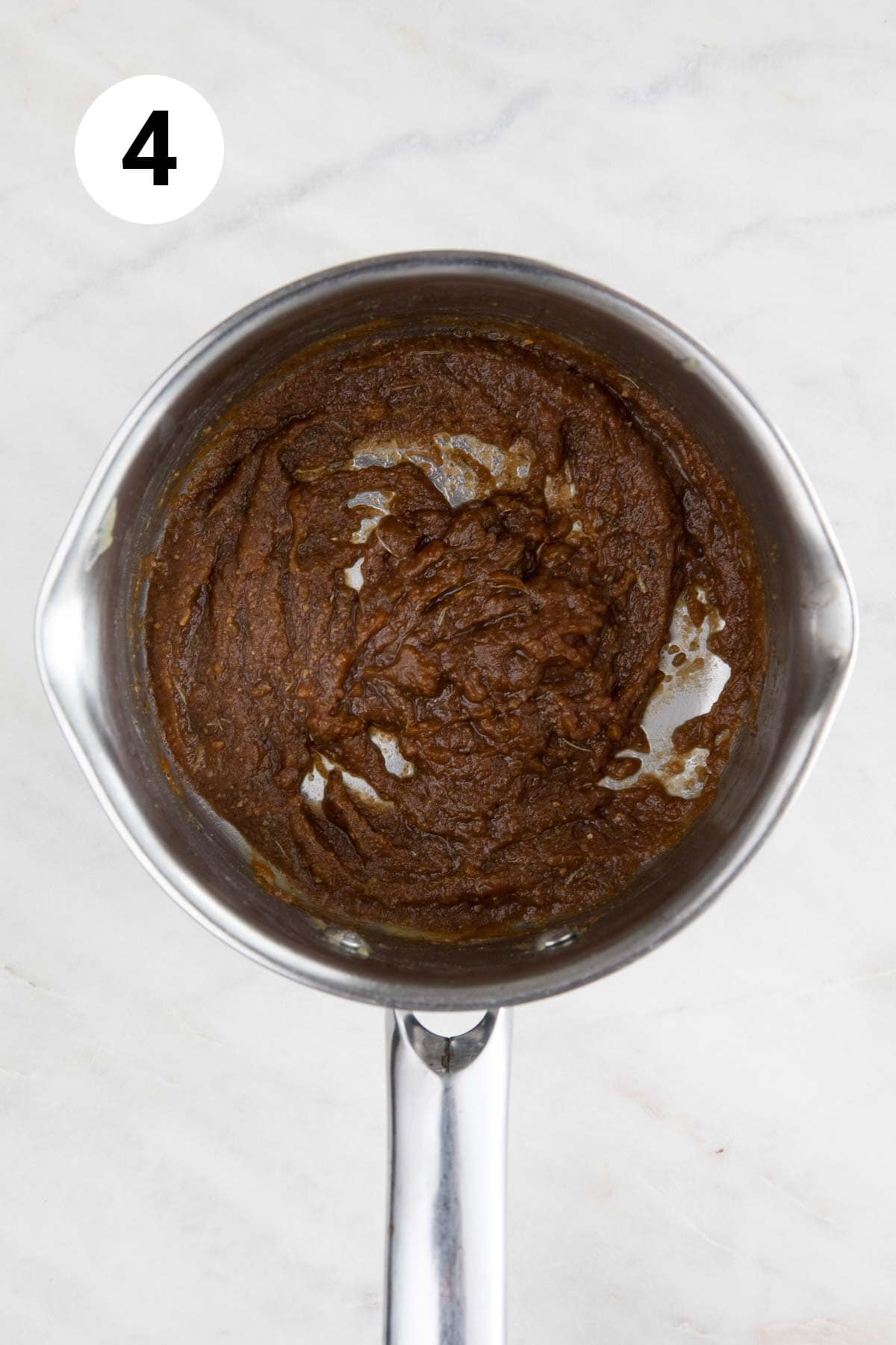 Saucepan with the cooked roux with spices, herbs, and soy sauce.