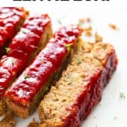 Slices of vegan lentil loaf garnished with fresh oregano.