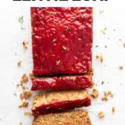 A sliced vegan lentil loaf with fresh oregano on top.