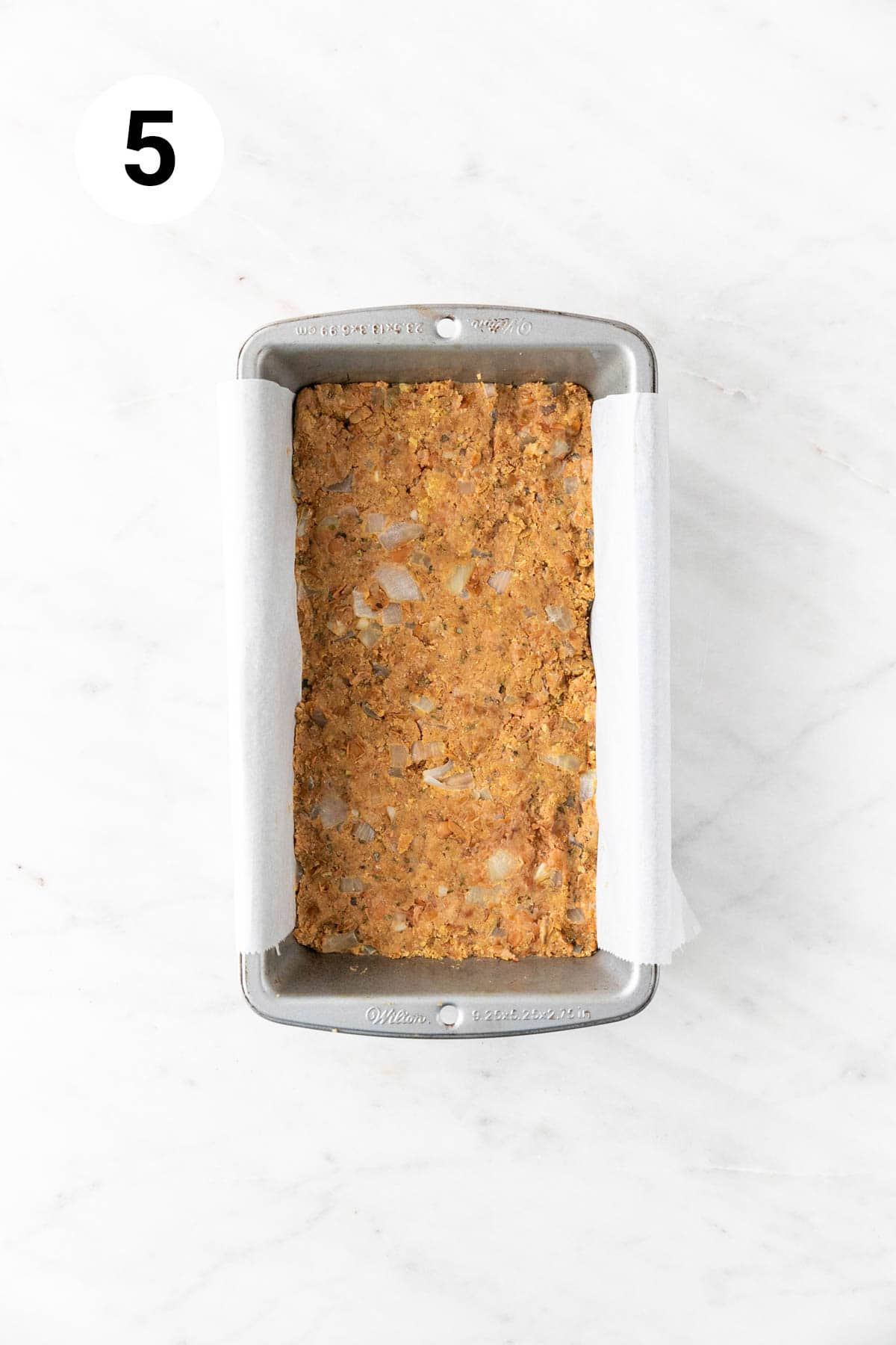 Vegan lentil loaf mixture in a lined loaf pan.