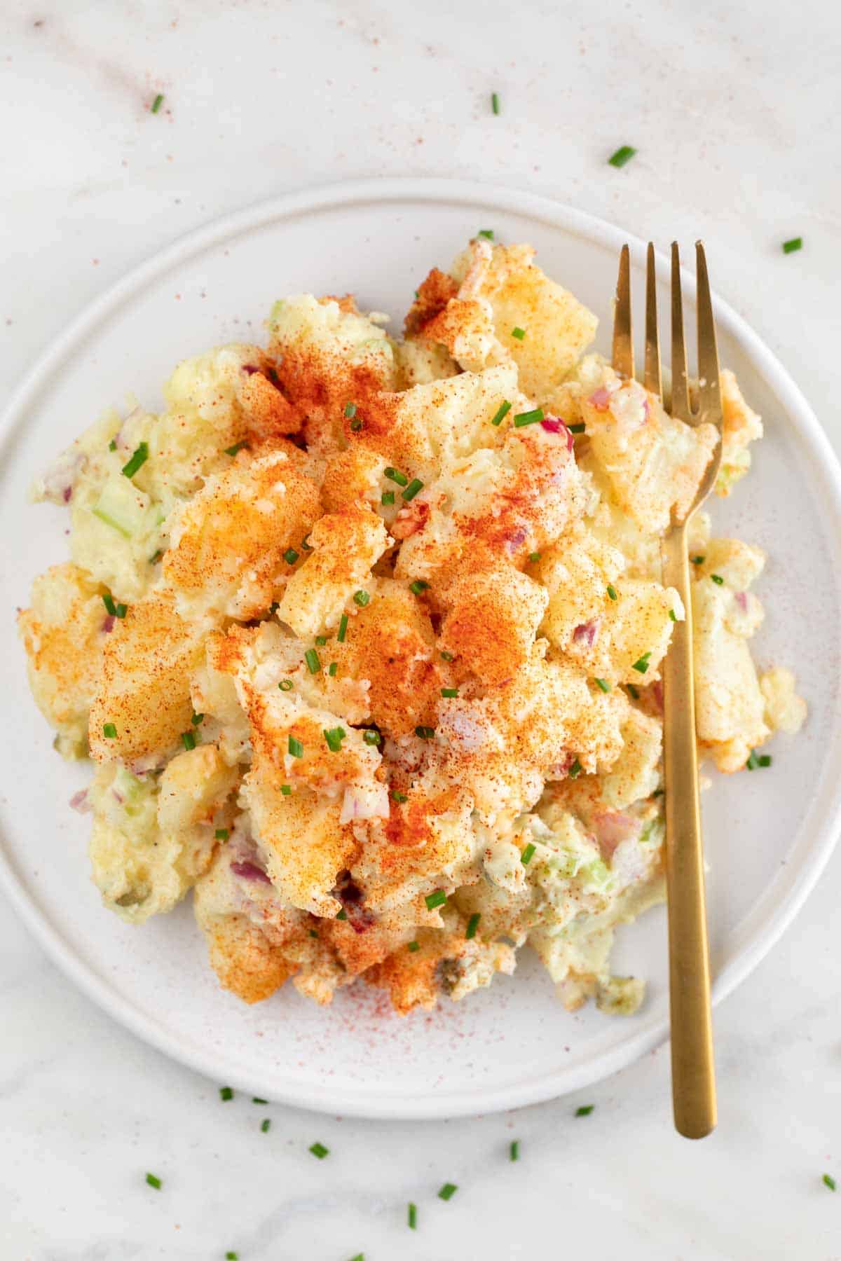 Plate of vegan potato salad with a fork.