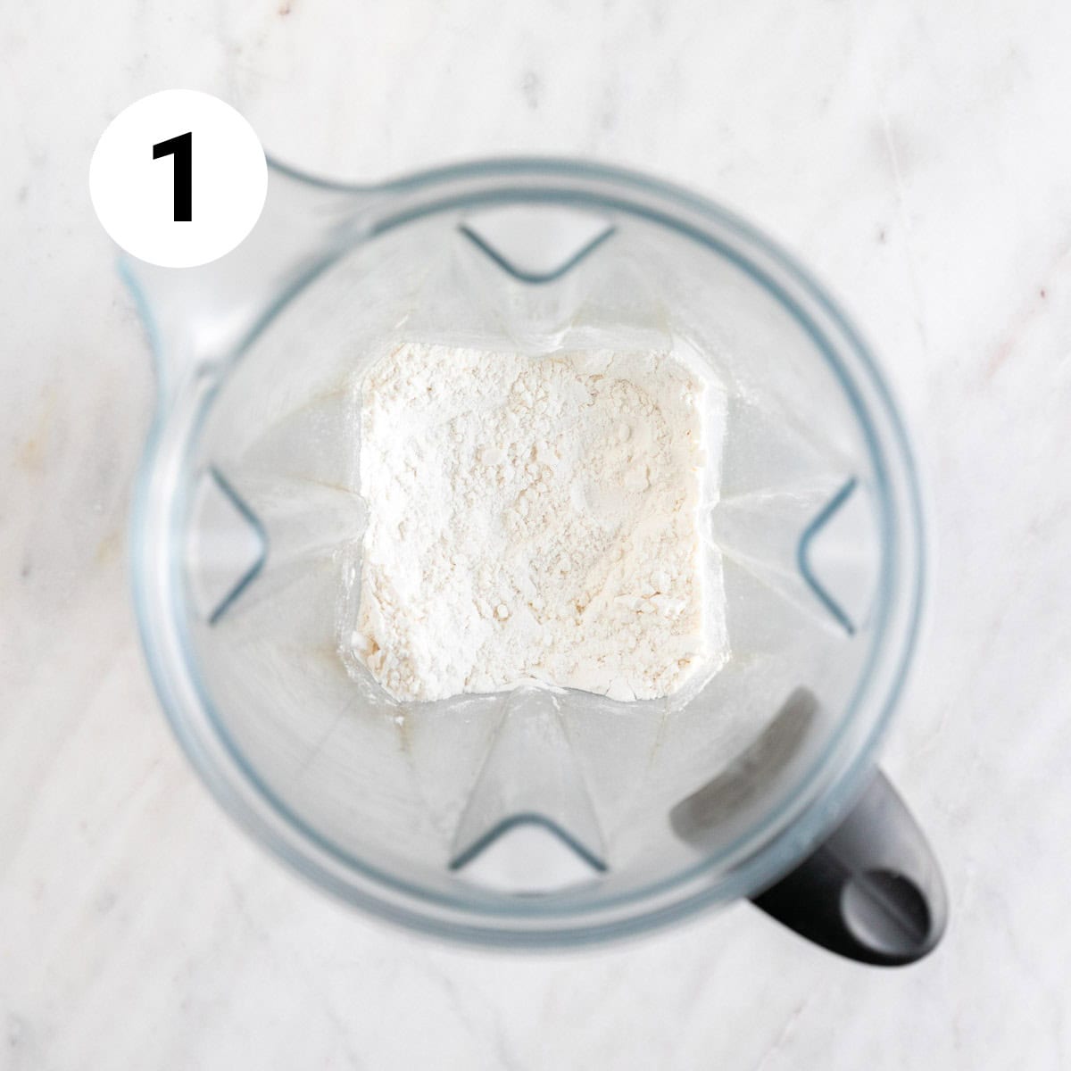 Granulated sugar and soy milk powder blended in a blender jar.
