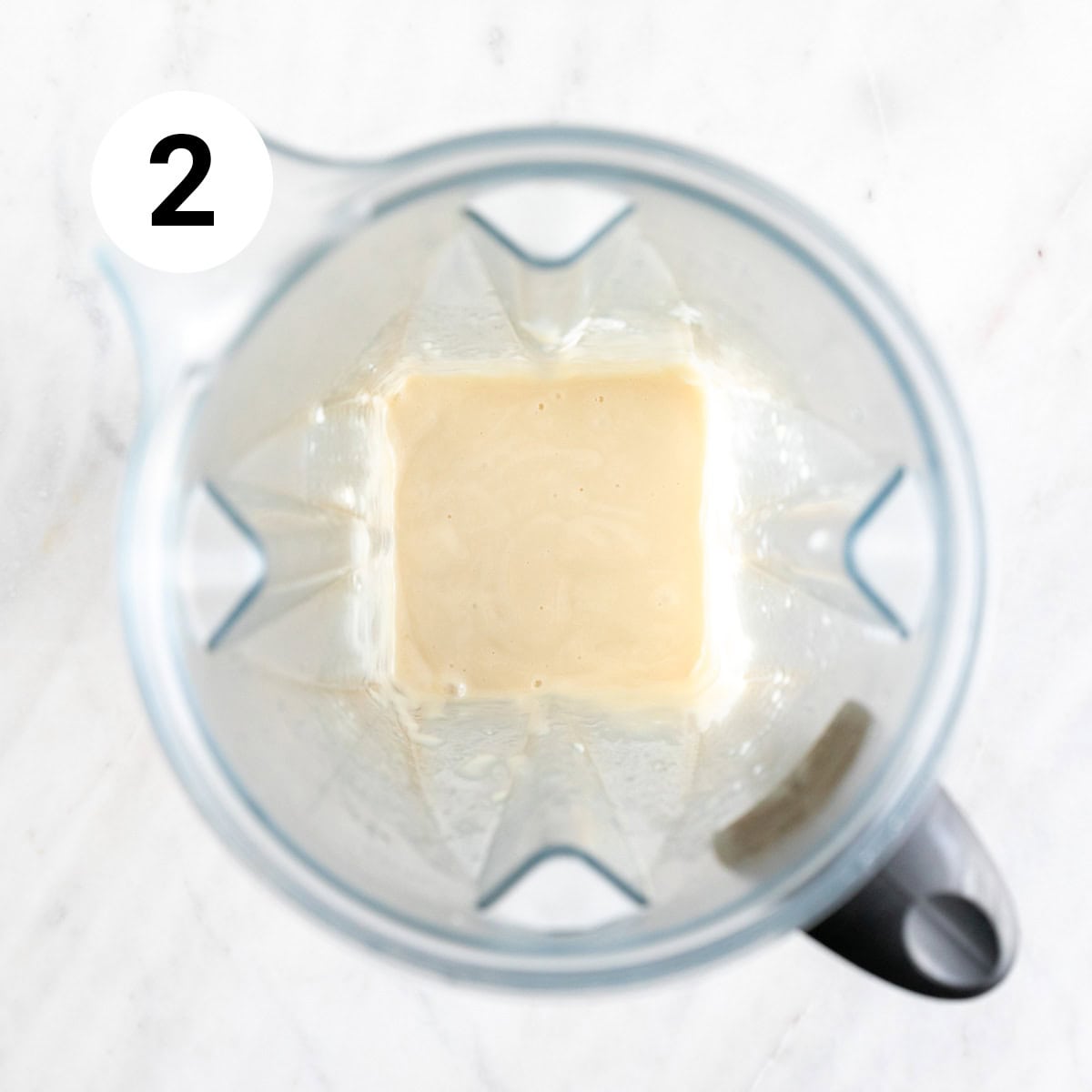 Vegan sweetened condensed milk in a blender jar.