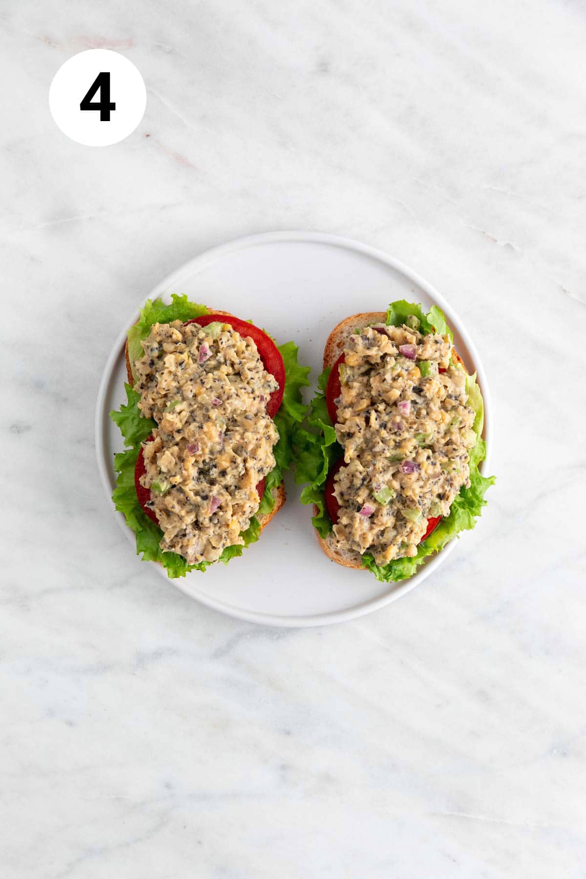 Vegan tuna on 2 slices of bread, with lettuce and tomato.