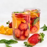 Square photo of 2 glass jars of fruit infused water