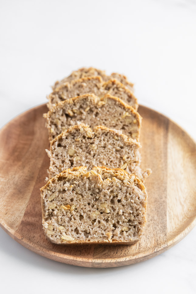 Photo of four slices of gluten-free bread on a wooden plate