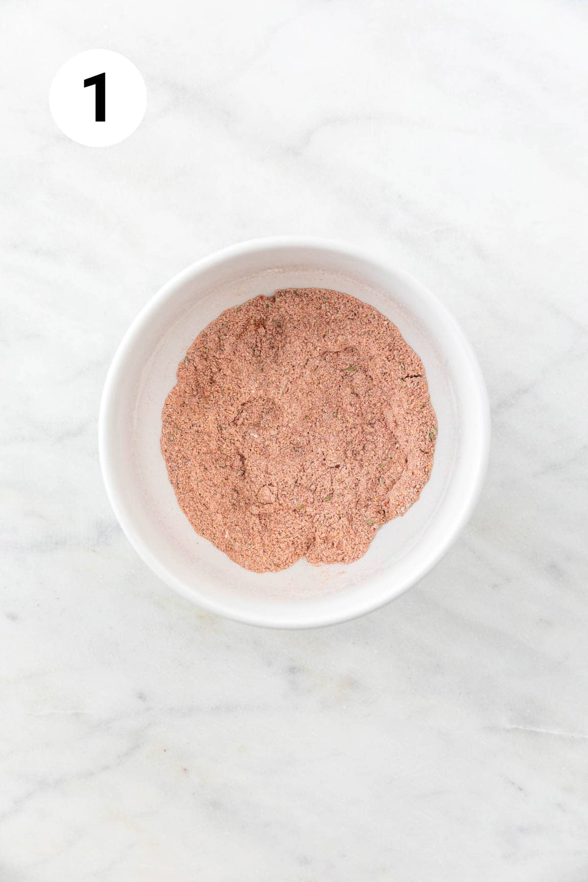Flour and spices mixed in a small bowl.