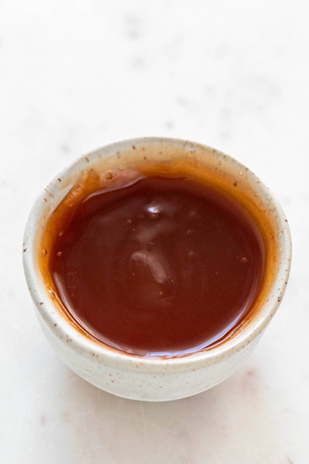 Small bowl with homemade sweet and sour sauce.