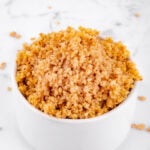 Photo of a bowl of cooked millet with a heading