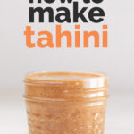 A picture of a glass container with homemade tahini and the words "How to make tahini"