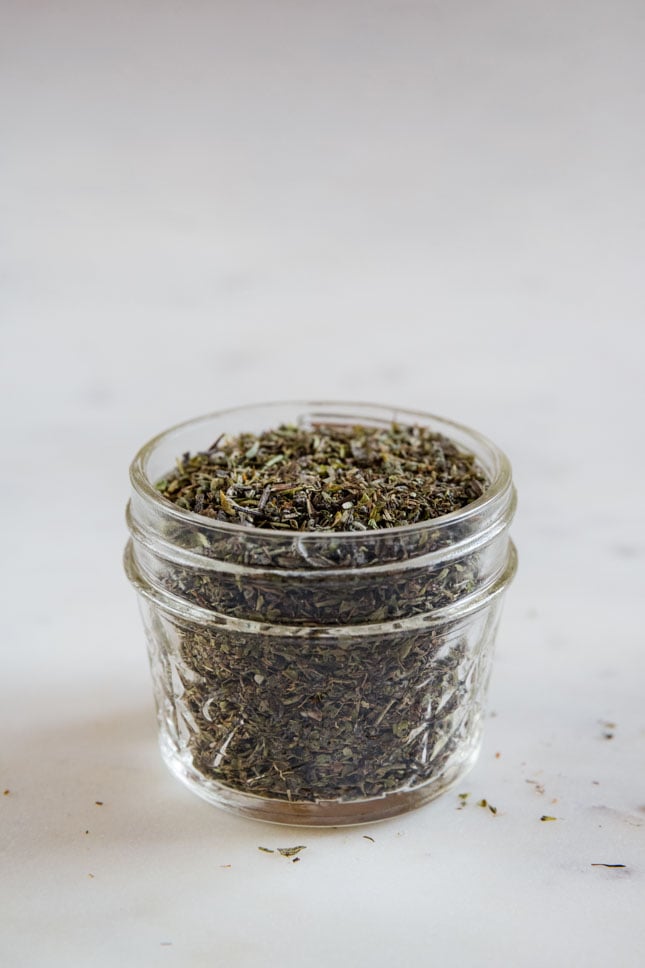 A side shot of a jar with Italian seasoning made from scratch
