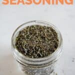 A close shot of a glass jar with homemade Italian seasoning with the words Italian seasoning