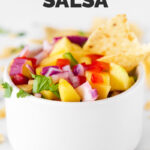 Side photo of a bowl of mango salsa with the words mango salsa