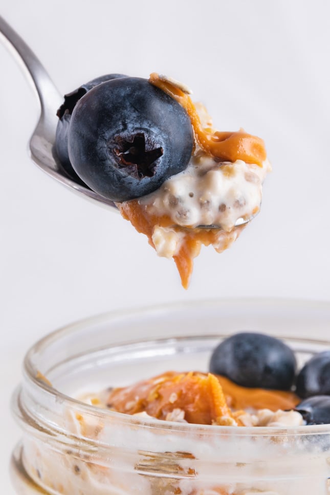 A spoonful of overnight oats and some blueberries