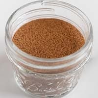 Square photo of a glass jar of pumpkin pie spice