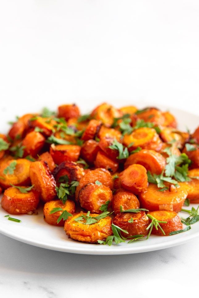 Side shot of a plate of roasted carrots