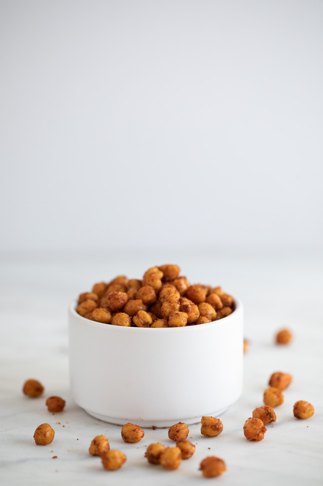 Side shot of a container with homemade roasted chickpeas