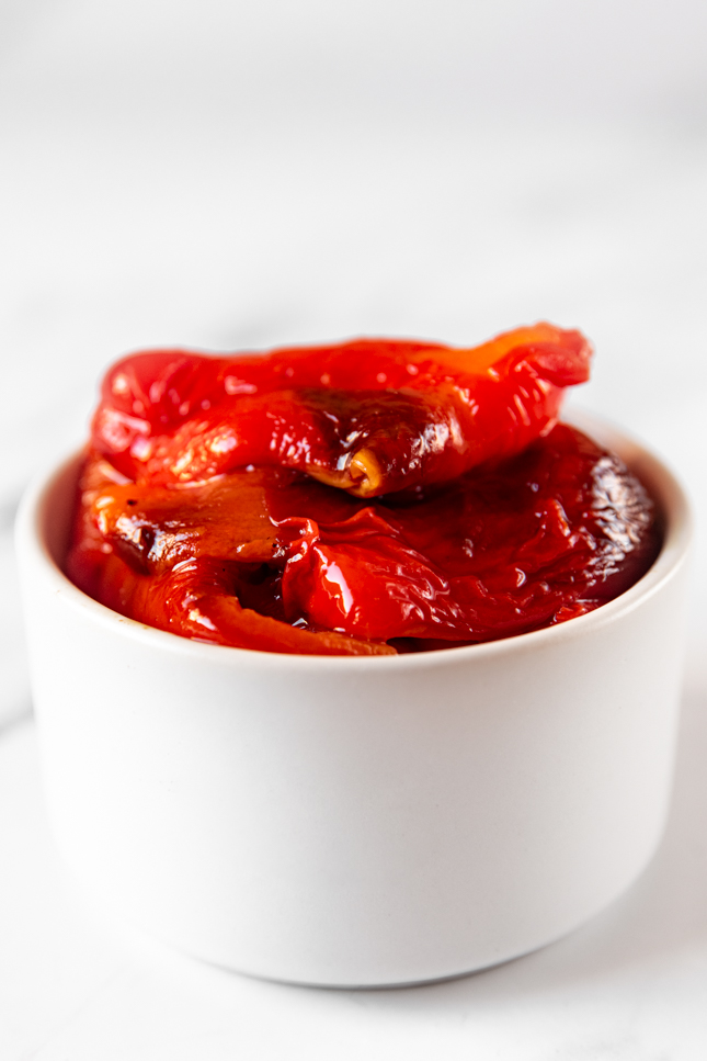 Close-up shot of a bowl of roasted red peppers