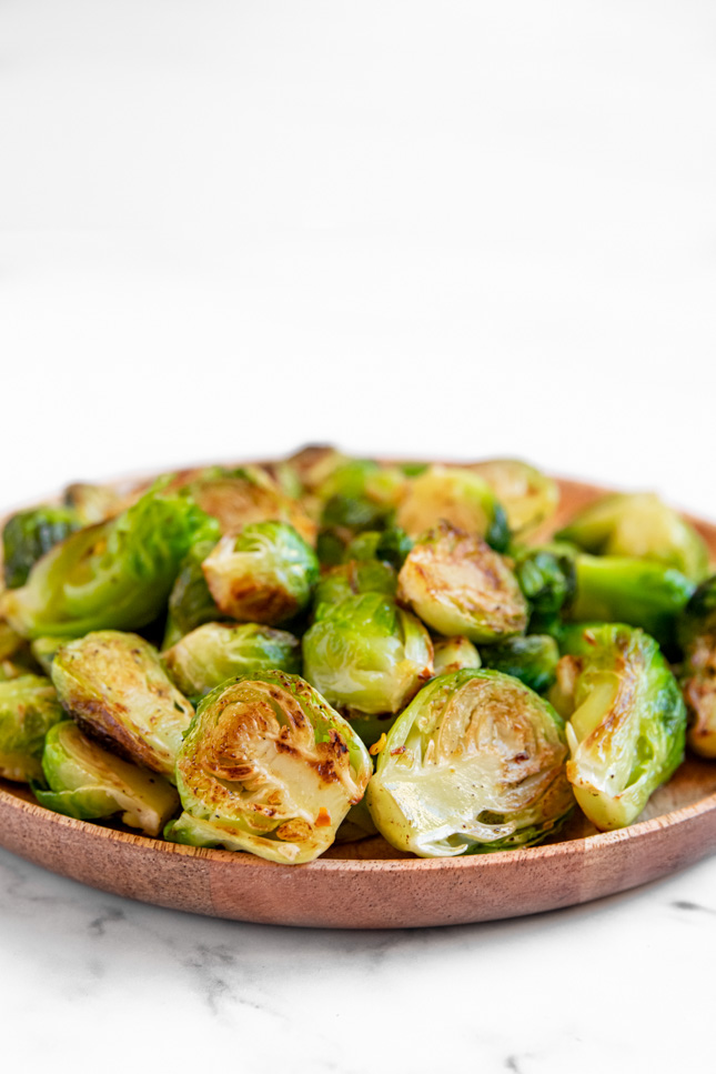 Side shot of a plate of sauteed Brussels sprouts