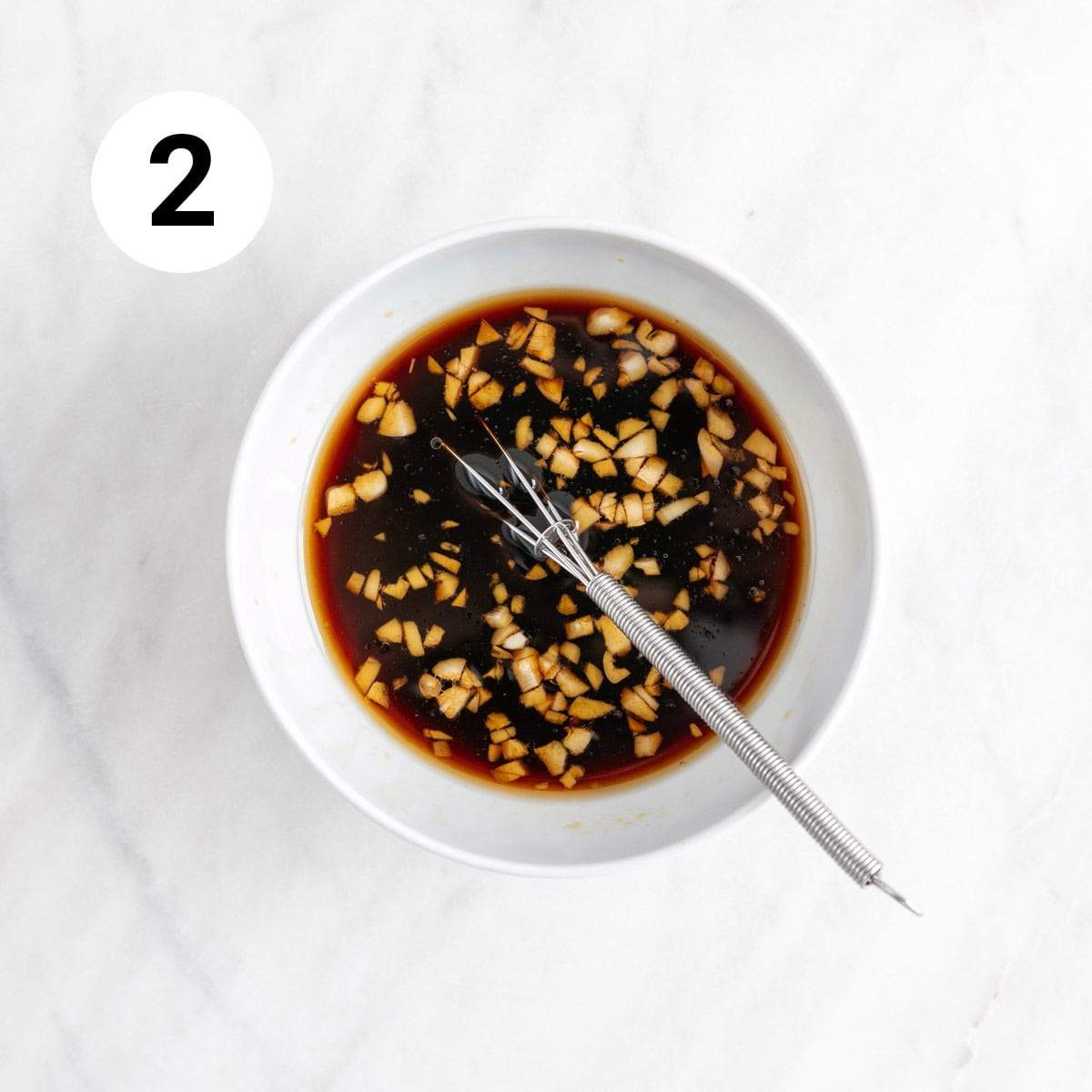 Sesame sauce in a bowl with a whisk before adding the slurry.
