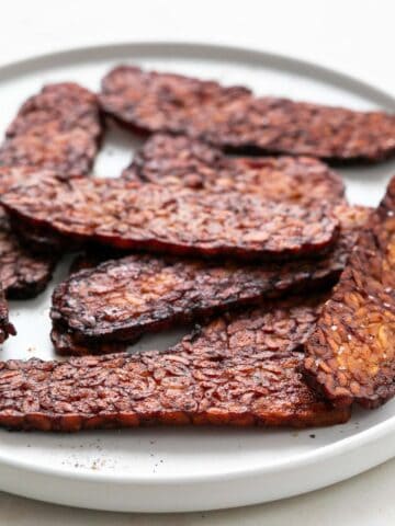 Plate with slices of smoky tempeh bacon.