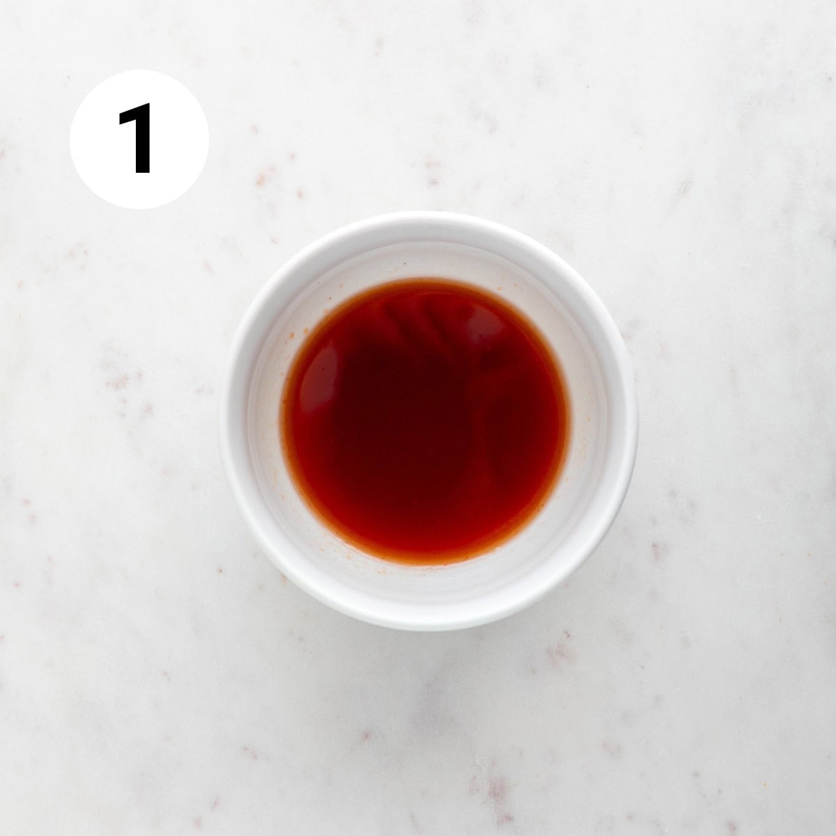 A bowl with ketchup, soy sauce, rice vinegar, and sugar mixed together.
