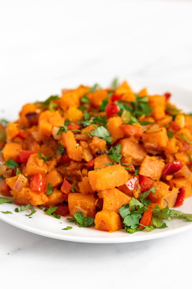 Side shot of a plate of sweet potato hash